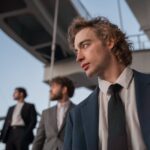 man in blue suit jacket with hoop earring