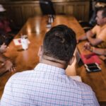 shallow focus photography of man facing backward