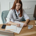 photo of woman writing on a desk